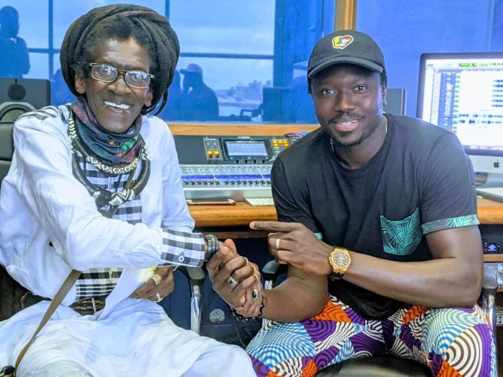 Cheikh Ibra Fam with fellow Baye Fall musician Cheikh Lo (left)